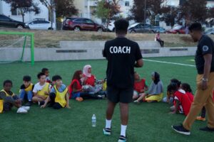 NewHolly youth gathering around for instruction and motivation from Intercity coaches. Photo credit to Intercity Soccer League.
