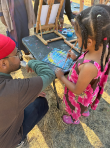 Youth explore painting at DNDA Fun Friday, an event where we provide free food, art, and games for folks to come and experience the joy of summer together.