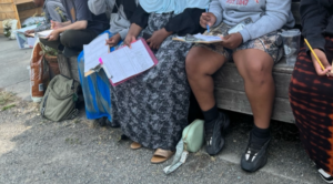 Teens working and learning about food and how they are culturally relevant. They planned to how they were going to plant the seed and the best way to plant them with compostable pots.