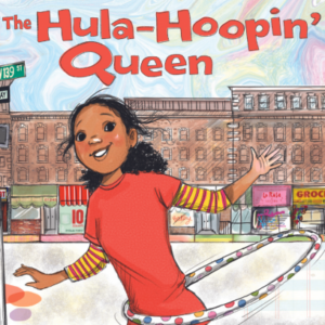 The children's book cover of The Hula Hoopin' Queen. The background is of Harlem, New York with red brick buildings and storefronts. The forefront is the main character, a young Black girl named Kameka with Black textured hair, smiling in an orange shirt twirling effortlessly with a polka dot hula hoop.