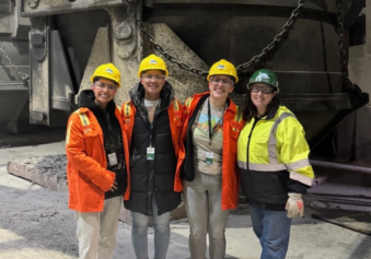 DNDA team members at steel mill with Nucor employee.