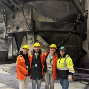 DNDA team members at steel mill with Nucor employee.